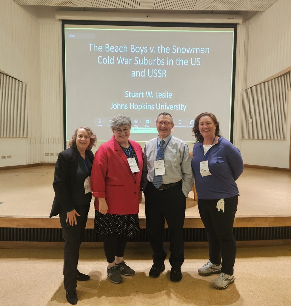 Prof. Amy Bix, Prof. Penelope Hardy, Prof. Leslie, and Assoc. Prof. Allison Marsh standing in front of his power point screen